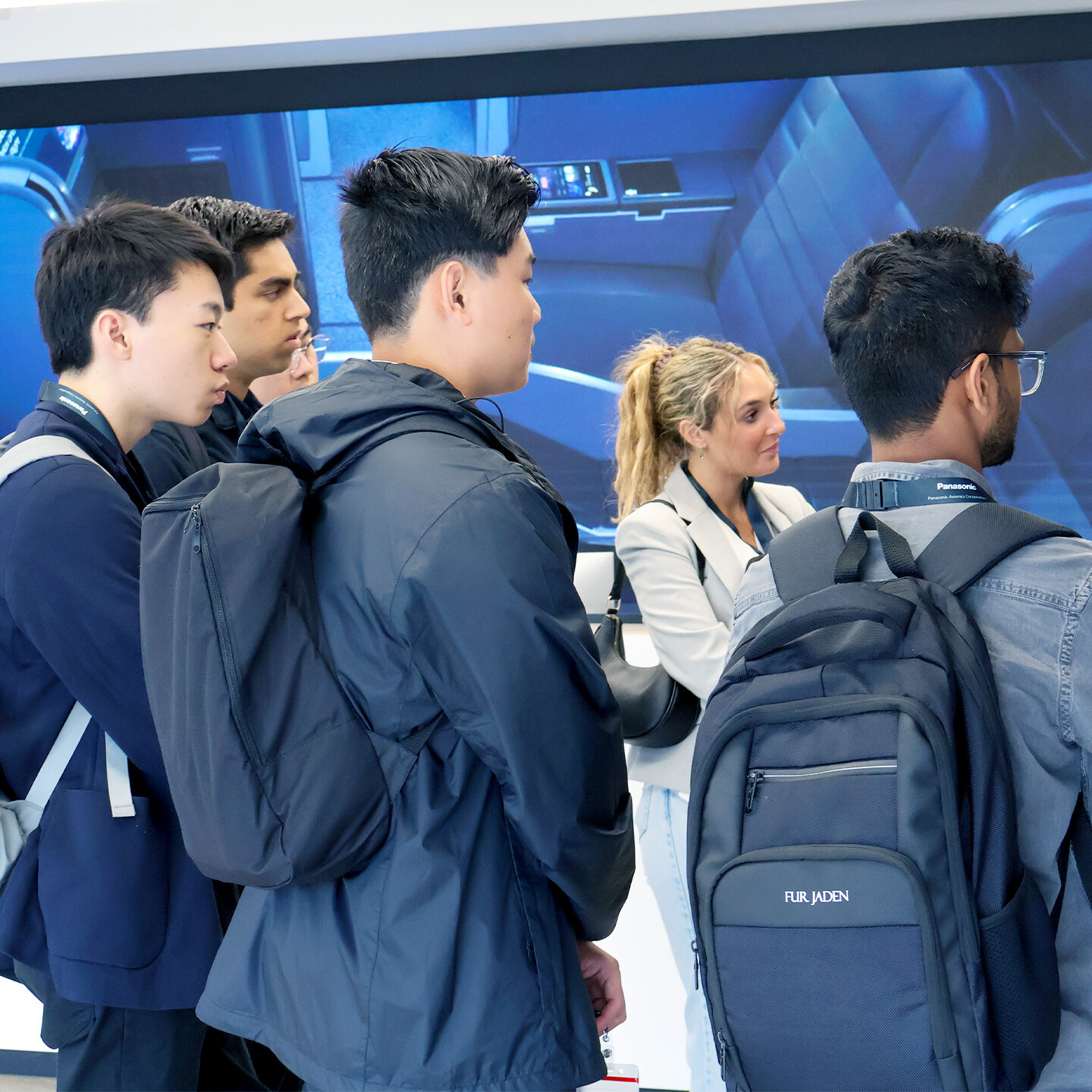 A group of 6 people listening to a presentation