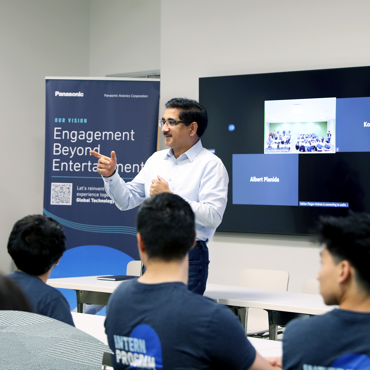 A person giving a presentation to a room full of people