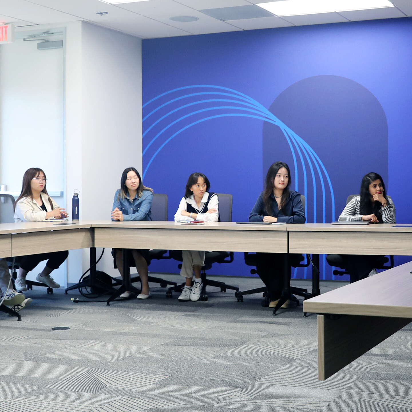 A group of around 5 women listening to presentation