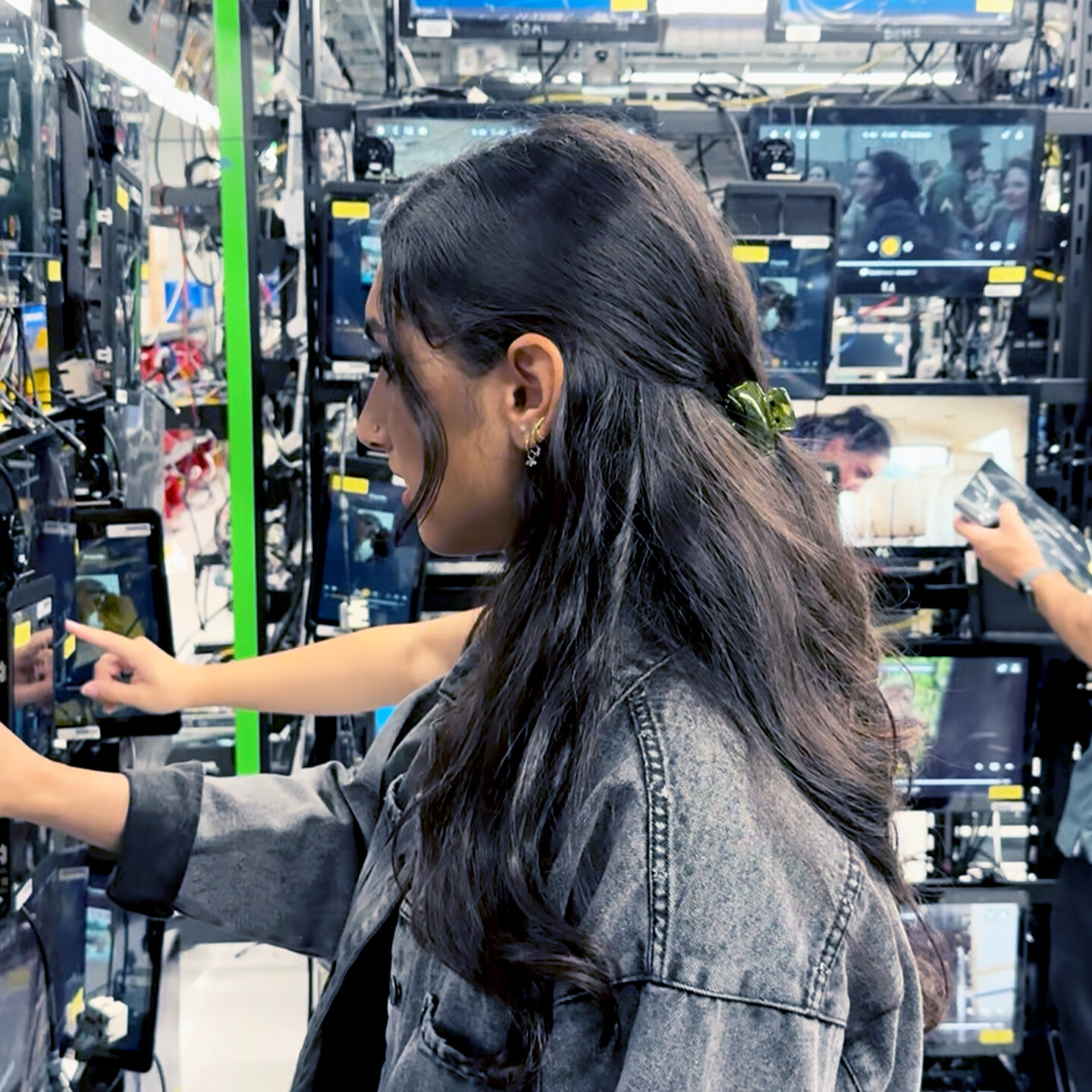 A person testing multiple Astrova screens in the center with two additional people conducting testing in the background