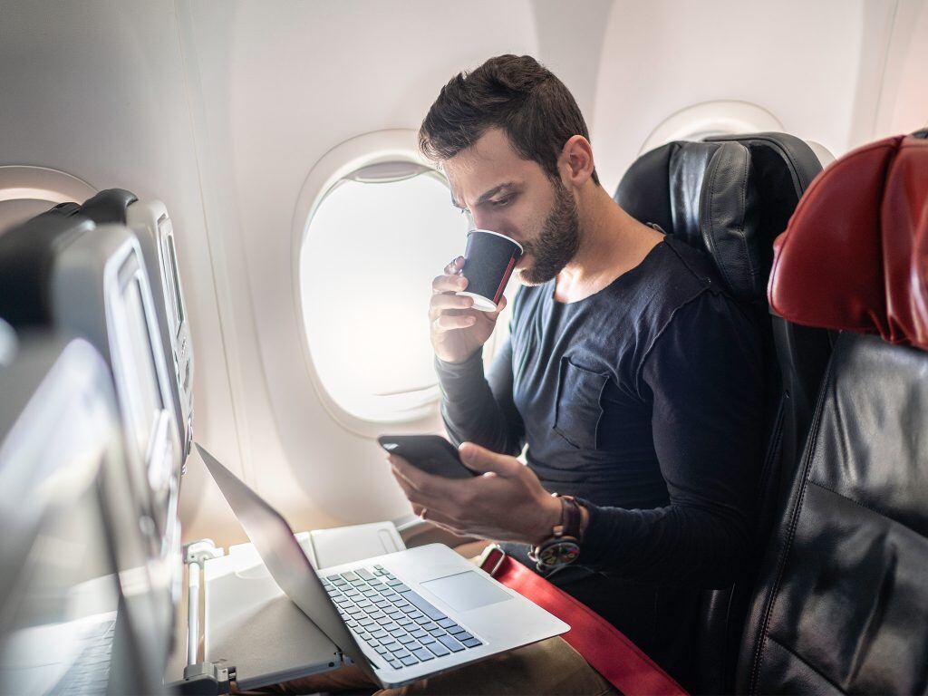 Man-on-cellphone-and-laptop-1024x768