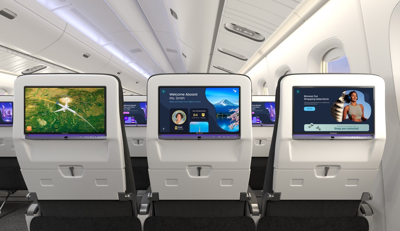 Three airplane seat-back screens displaying a map, a welcome message for Tokyo flight, and a shopping promotion