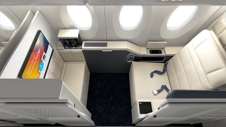 Top-down view of a luxurious airplane cabin with a cream leather seat, entertainment screen, and storage area