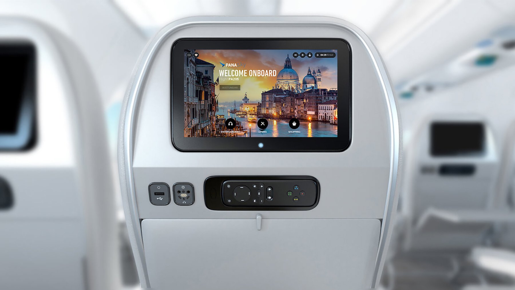 Back of an airplane seat with an entertainment screen displaying a welcome message and cityscape image